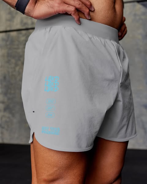 This ad features a close-up shot of a man wearing gray athletic shorts. The shorts have the brand name printed verticall