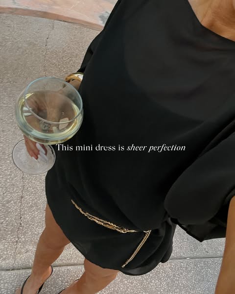 The ad features a first-person point of view of a customer wearing a black mini dress with a gold chain belt. The custom
