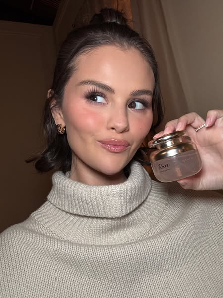 This ad features Selena Gomez holding a Rare Beauty product. The ad is shot in a selfie style.