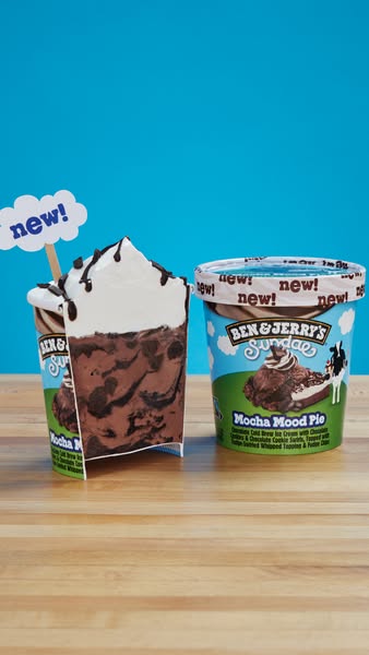 An image showcasing the new Ben & Jerry's Sundae Mocha Mood Pie ice cream flavor, with a sliced pint and an inta