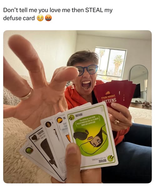 This ad uses a user-generated style image to promote the Exploding Kittens card game. It shows a woman playfully upset t