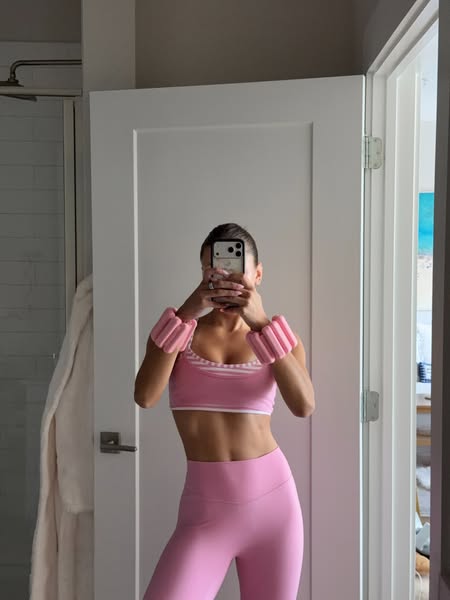 This ad features a person taking a mirror selfie in pink activewear with Bala Bangles on their wrists. The ad is likely 