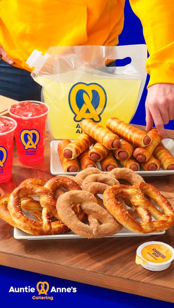 This ad focuses on an array of Auntie Anne's snack items including original pretzels, pretzel dogs, drinks, and chee