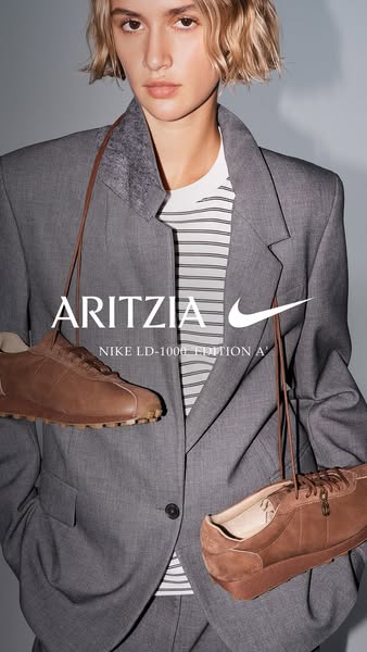 This ad features a model wearing a grey suit with brown shoes draped around their neck, showcasing a collaboration betwe