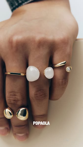 This ad showcases a hand wearing multiple rings from the brand PDPAOLA.