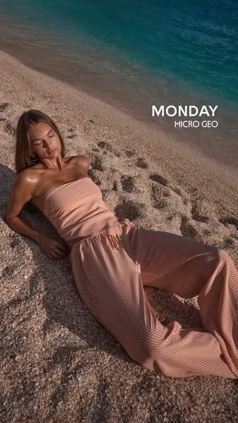 An image ad featuring a model in a matching set. The model is lying on a beach with the ocean in the background. The bra