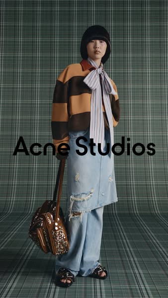 An Acne Studios ad features a model in the brand's clothing and accessories.