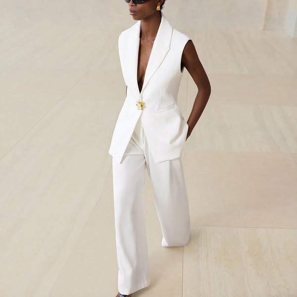 This ad features a woman wearing a white suit. The ad is likely for the suit itself or the brand that makes it.