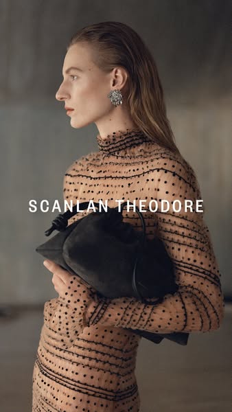 This ad showcases the Scanlan Theodore brand with a woman holding a suede bag.