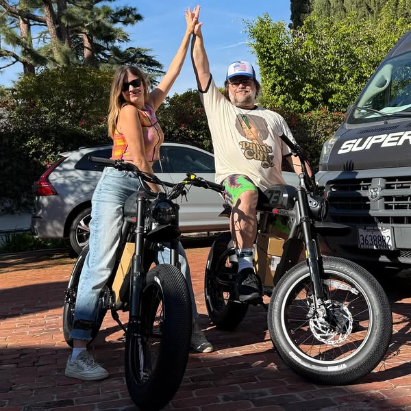 This ad features a photo of a man and woman on Super73 electric bikes. They are giving each other a high five. The ad is