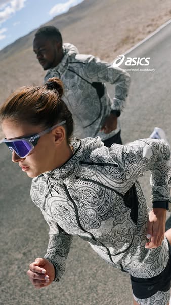 This ad from Asics features a man and woman running on a road. They are both wearing a patterned jacket and running shor