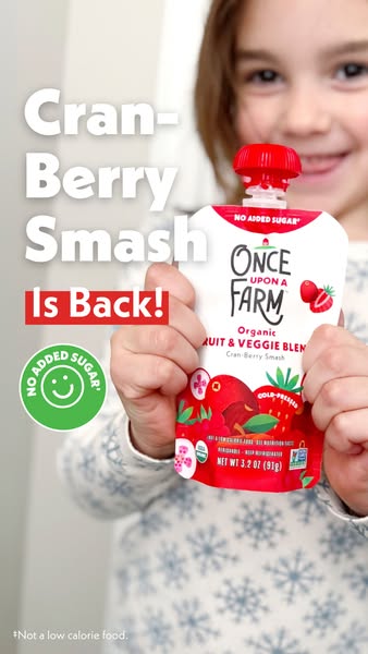 This ad features a young girl holding a pouch of Once Upon a Farm's Cran-Berry Smash organic fruit and veggie blend.
