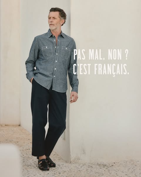 The ad features a man wearing a blue shirt and black pants, leaning against a white wall. The text overlay asks, "P