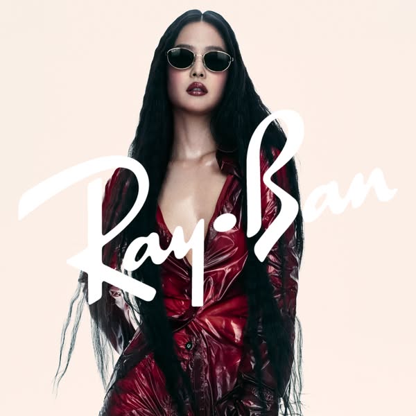 This ad features a model wearing Ray-Ban sunglasses, showcasing the product against a soft, neutral backdrop with the br