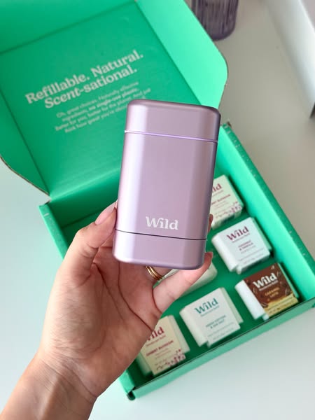 This ad showcases Wild deodorant's refillable and natural deodorant system. The ad features a hand holding a lilac d
