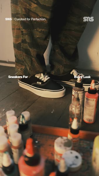 This image ad for SNS features a pair of Vans mule sneakers. The image presents a collection of paint supplies, alluding