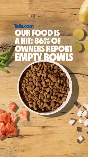 This image ad for Tails.com features a bowl of dog food surrounded by fresh ingredients, emphasizing the brand's com