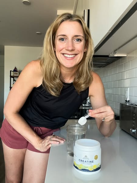This ad features a woman in her kitchen preparing a drink with Ancient Nutrition's Creatine + Collagen powder. She i
