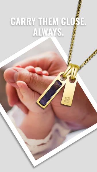 This ad features a close-up photo of a gold necklace with two pendants hanging over an image of a parent holding their n