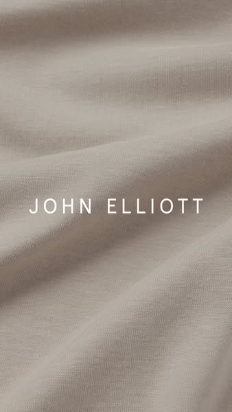 This ad features a close-up shot of a John Elliott t-shirt, emphasizing the brand name and the texture of the fabric.