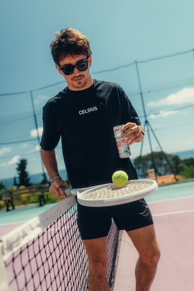 This ad features a man on a tennis court holding a can of Celsius energy drink. He is wearing a Celsius branded shirt.