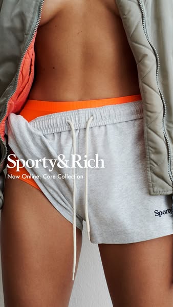This image ad features a close-up photo of someone wearing Sporty & Rich heather grey shorts with white drawstrings