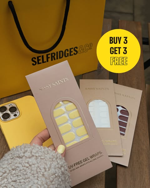 The ad features a hand holding a pack of Sassy Saints UV-Free Gel Wraps, with additional packs and a Selfridges bag in t