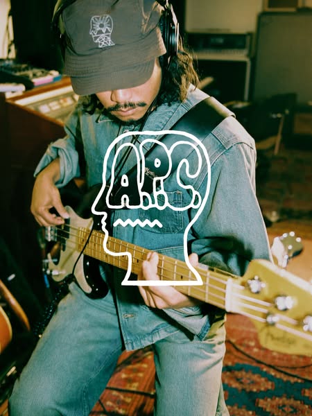 This ad features a musician playing a bass guitar. An overlay featuring the A.P.C. logo is present on the image.