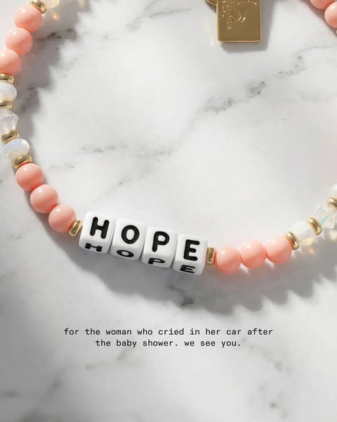 This ad features a close-up of a beaded bracelet with the word "HOPE" spelled out in square letter beads. The 