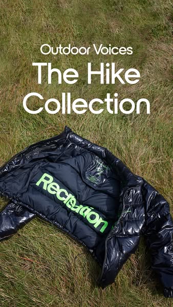 This ad showcases Outdoor Voices' Hike Collection, featuring a shiny black puffer jacket laid on a bed of grass. The
