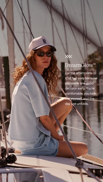 The ad features a woman on a boat wearing a light blue matching set with a hat. The DreamGlow™ tagline is 'For the a