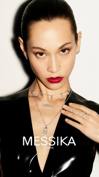 This ad showcases a model wearing diamond jewelry from Messika Paris in a highly polished studio shot.