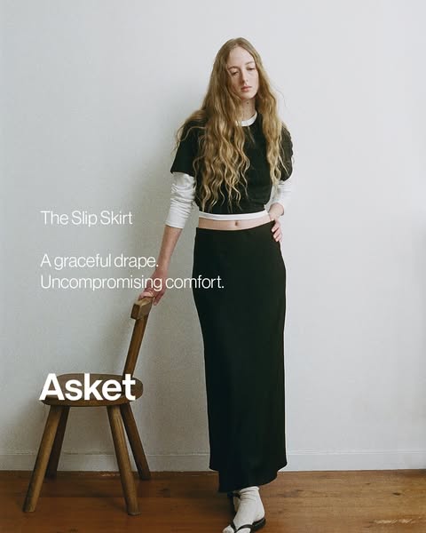 This ad features a woman modeling the Asket Slip Skirt and highlights its graceful drape and uncompromising comfort.