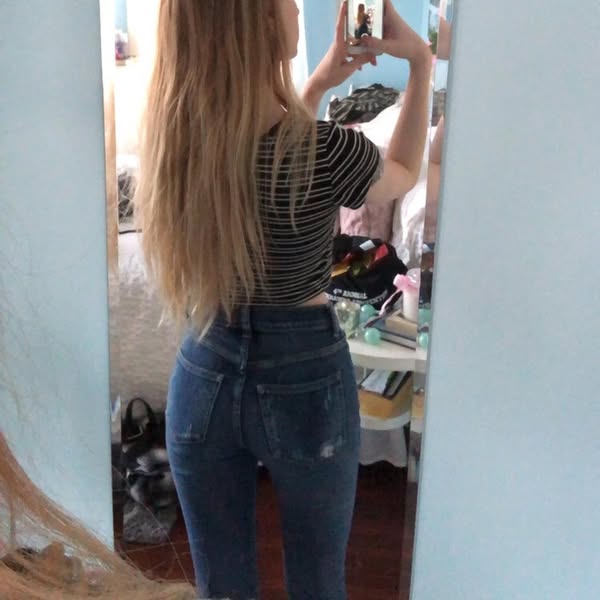 This ad features a woman taking a mirror selfie while wearing jeans. The jeans are the main focus of the ad.