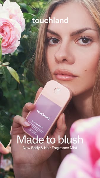 A woman poses outdoors with a Touchland body and hair fragrance mist among foliage. The ad highlights the new 'Made 