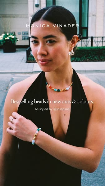 This ad showcases Monica Vinader jewelry, specifically beaded bracelets and necklaces, styled by @sasha.mel. It highligh
