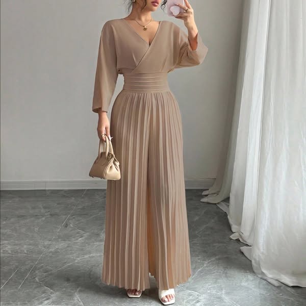 An image ad showcasing a woman wearing a beige jumpsuit and holding a matching purse.