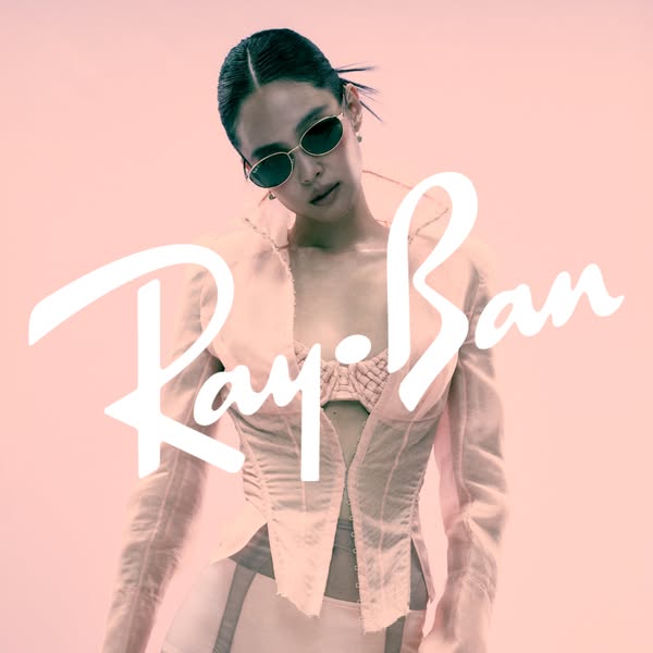 This ad features a woman wearing sunglasses from Ray-Ban. The Ray-Ban logo is displayed prominently over the image of th