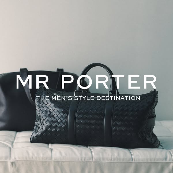 This image ad for Mr. Porter features two black leather bags on a white tufted surface. The ad is simple and elegant, wi