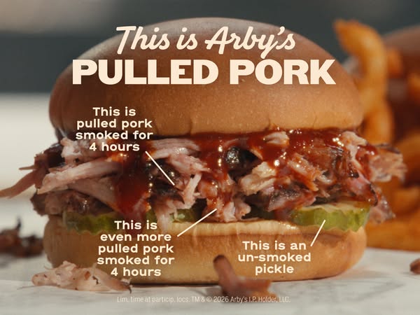 This image ad showcases Arby's Pulled Pork sandwich with an up-close product shot. Annotations highlight the prepara