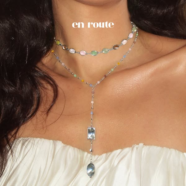 This image ad showcases a jewelry brand with a close-up shot of a woman wearing two delicate necklaces. The design empha