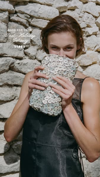 This ad showcases a STAUD bag, emphasizing its suitability for post-holiday getaways. The ad features a model holding th