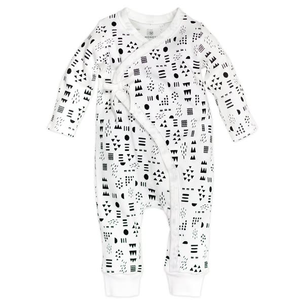 This ad features a baby onesie against a white background. The onesie is white with long sleeves and a geometric pattern