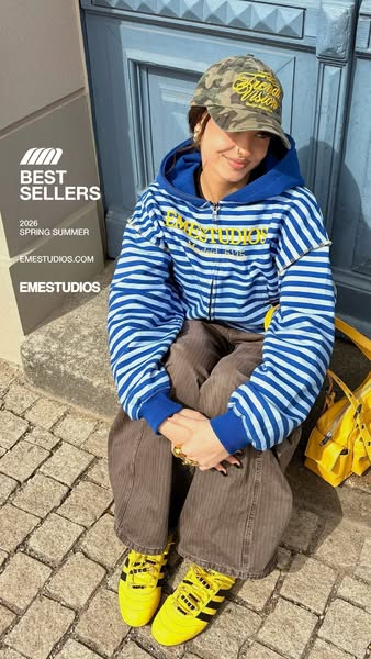 This ad features a woman modeling EMESSTUDIOS apparel. The image is promoting the brand's best sellers for the sprin