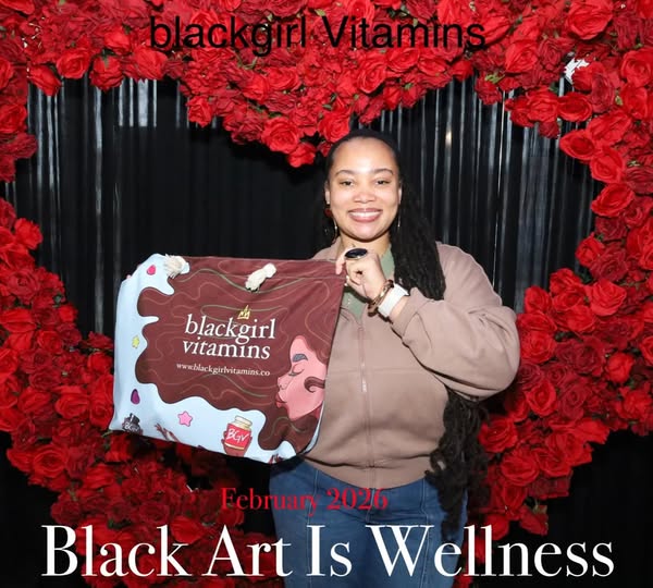 This image ad for blackgirl Vitamins features a woman standing in front of a red rose backdrop in the shape of a heart, 