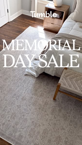 This ad promotes Tumble rugs during a Memorial Day sale. The image showcases a rug in a bedroom setting, styled with fur
