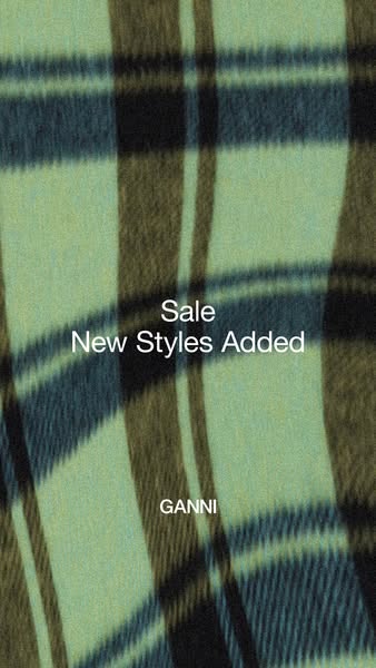 This image ad for GANNI features a close-up shot of a plaid fabric with the text "Sale New Styles Added" and t