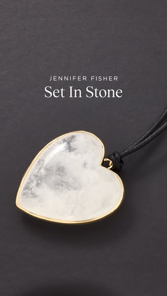 This ad showcases a Jennifer Fisher heart pendant necklace, emphasizing its luxurious design and stone.