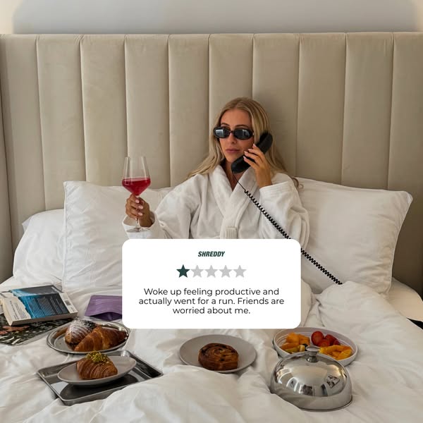 This ad features a testimonial from a satisfied Shreddy customer. The customer is shown in bed with a breakfast spread, 