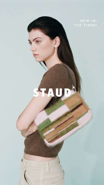 This ad showcases the new Timmy bag from the brand Staud. The ad features a woman holding the bag in front of a light bl